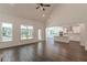 Spacious living room with high ceilings, wood floors, and lots of natural light from many windows at 4075 O Henry Ct, Mcdonough, GA 30252
