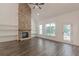 Light-filled living area with a stone fireplace, built-in shelves, and wood floors at 4075 O Henry Ct, Mcdonough, GA 30252