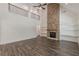 Open-concept living area with fireplace, wood floors, built-in shelves, and a vaulted ceiling at 4075 O Henry Ct, Mcdonough, GA 30252