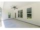 Spacious covered patio with a ceiling fan, door, and large windows overlooking the landscaped backyard at 4075 O Henry Ct, Mcdonough, GA 30252