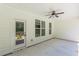 Covered patio with ceiling fan, door to inside, and multiple windows looking out to greenery at 4075 O Henry Ct, Mcdonough, GA 30252