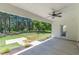 Covered patio with a ceiling fan, a door leading to the backyard, and a peaceful outdoor view at 4075 O Henry Ct, Mcdonough, GA 30252