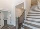 An open foyer showcases a staircase with wood treads, white risers, and a dark metal railing at 4075 O Henry Ct, Mcdonough, GA 30252