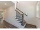 Hallway with staircase featuring wood and iron banister, next to a sunny window at 4075 O Henry Ct, Mcdonough, GA 30252