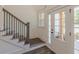 Entryway staircase with wood and iron banister, next to a glass front door at 4075 O Henry Ct, Mcdonough, GA 30252
