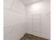 A walk-in closet with built-in white wire shelving and dark wood-look flooring provides ample storage at 4075 O Henry Ct, Mcdonough, GA 30252