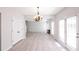 Sunlit dining room leads to the living room with hardwood floors and white trim at 436 Crestmont Ln, Canton, GA 30114
