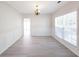 The dining room is bright with elegant wainscoting, neutral walls, and vinyl floors at 436 Crestmont Ln, Canton, GA 30114