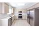 Bright kitchen with stainless steel appliances, modern white countertops and backsplash, plus wood floors at 436 Crestmont Ln, Canton, GA 30114