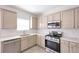 Bright kitchen featuring modern stainless steel appliances, light countertops, and white hexagon backsplash at 436 Crestmont Ln, Canton, GA 30114