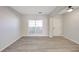 Bright living room features neutral walls, hardwood flooring, and natural light from the window at 436 Crestmont Ln, Canton, GA 30114