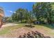 Spacious backyard featuring a well-maintained lawn, mature trees, and a fenced perimeter at 5166 Vivid Dr, Stone Mountain, GA 30087