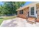 Charming backyard with a brick patio, enclosed with a chain-link fence, offering privacy and a safe outdoor space at 5166 Vivid Dr, Stone Mountain, GA 30087