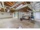 Spacious unfinished basement with visible ductwork, concrete floor, and ample room for storage and creative projects at 5166 Vivid Dr, Stone Mountain, GA 30087