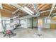 Unfinished basement with exposed ductwork and concrete flooring offering ample space for various activities and storage at 5166 Vivid Dr, Stone Mountain, GA 30087
