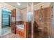 Bathroom with a shower and tub combination enclosed in a glass door, alongside a vanity and a door to the walk-in closet at 5166 Vivid Dr, Stone Mountain, GA 30087