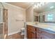 Well-lit bathroom with a large mirror, vanity, and a glass-enclosed shower, providing a clean and modern aesthetic at 5166 Vivid Dr, Stone Mountain, GA 30087