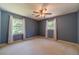 Bedroom featuring two windows with curtains and natural light at 5166 Vivid Dr, Stone Mountain, GA 30087