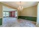 Formal dining room with chandelier, large windows, and an open layout connected to the living room at 5166 Vivid Dr, Stone Mountain, GA 30087