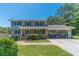 Charming two-story home with brick facade, shutters, landscaped front yard, and a spacious two-car garage at 5166 Vivid Dr, Stone Mountain, GA 30087