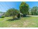 Lush green front yard with mature trees and landscaping provides a serene setting at 5166 Vivid Dr, Stone Mountain, GA 30087