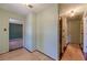Hallway with wood floors leading to a room with carpeted floors at 5166 Vivid Dr, Stone Mountain, GA 30087