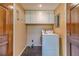 Functional laundry room with ample cabinet space and a modern washer and dryer at 5166 Vivid Dr, Stone Mountain, GA 30087