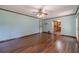 Hardwood floor, light blue walls, and view to kitchen and door to backyard in this open floor plan at 5166 Vivid Dr, Stone Mountain, GA 30087