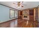 Cozy living room with a brick fireplace, built-in bookshelves, and hardwood flooring at 5166 Vivid Dr, Stone Mountain, GA 30087