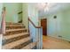 Traditional carpeted staircase with wooden handrail and trim, leading to the upper level of the home at 5166 Vivid Dr, Stone Mountain, GA 30087