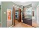 Spacious walk-in closet with wood bi-fold doors, carpet, shelves, and a storage bench below the bright window at 5166 Vivid Dr, Stone Mountain, GA 30087