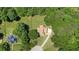 Aerial view of the property showing a sprawling lot, mature trees, and a long driveway at 940 Planters Pl, Loganville, GA 30052