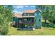 Charming two-story home featuring a large deck overlooking a spacious backyard and mature trees at 940 Planters Pl, Loganville, GA 30052