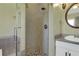 Bathroom featuring glass enclosed shower with tile surround and neutral colored walls at 940 Planters Pl, Loganville, GA 30052