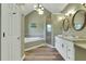 This large bathroom features a soaking tub, glass enclosed shower, and double sink vanity at 940 Planters Pl, Loganville, GA 30052