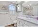 Bright bathroom featuring a vanity, window with blinds, and a shower with a floral-themed curtain at 940 Planters Pl, Loganville, GA 30052
