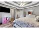 Bedroom featuring wood floors, a coffered ceiling, and access to ensuite bathroom at 940 Planters Pl, Loganville, GA 30052