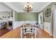 Elegant dining room featuring wainscoting, chandelier, and hardwood floors is perfect for creating memorable dining experiences at 940 Planters Pl, Loganville, GA 30052