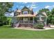 Charming two-story home with a well-manicured front yard and inviting covered porch at 940 Planters Pl, Loganville, GA 30052