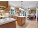 Spacious kitchen featuring stainless steel appliances, an island and tile flooring perfect for cooking and gathering at 940 Planters Pl, Loganville, GA 30052