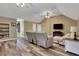 Comfortable living room featuring wood floors, a ceiling fan, and a comfortable recliner at 940 Planters Pl, Loganville, GA 30052