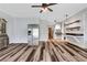 Spacious living area boasting wood floors, light walls, and a stainless steel refrigerator at 940 Planters Pl, Loganville, GA 30052