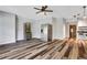 Open living room with wood floors, stainless steel refrigerator, and light gray walls at 940 Planters Pl, Loganville, GA 30052