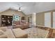 Living room featuring wood floors, vaulted ceiling, and multiple seating options at 940 Planters Pl, Loganville, GA 30052