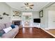 Inviting living room boasts a brick fireplace, ceiling fan and views into the dining room, creating a cozy and open space at 940 Planters Pl, Loganville, GA 30052