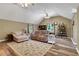 Spacious living room with vaulted ceiling, ceiling fan, hardwood flooring, and cozy seating area at 940 Planters Pl, Loganville, GA 30052