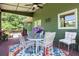 Relaxing covered patio featuring cozy seating and lush surroundings at 940 Planters Pl, Loganville, GA 30052