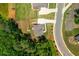 Aerial view of a home featuring a driveway, landscaped yard, and a cozy outdoor seating area at 1013 Liberty Springs Dr, Woodstock, GA 30188