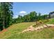 An expansive backyard, complemented by elegant wooden steps, offers a picturesque landscape with natural beauty and privacy at 1013 Liberty Springs Dr, Woodstock, GA 30188