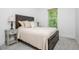 Bedroom with a rustic wood headboard, neutral bedding, and a side table with decorative lamps at 1013 Liberty Springs Dr, Woodstock, GA 30188